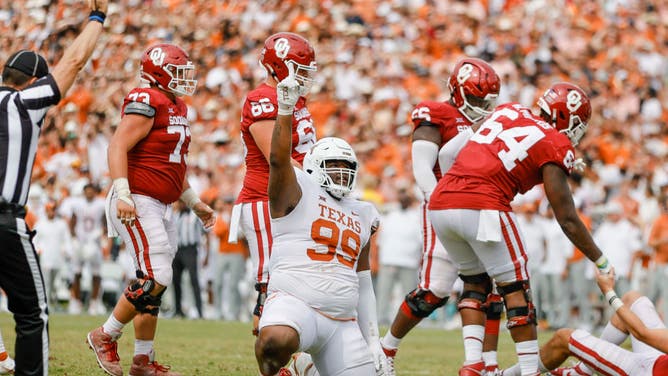 Texas Longhorns defensive lineman Keondre Coburn points to the sky after sacking Oklahoma Sooners QB Davis Beville at the Cotton Bowl Stadium in Dallas.