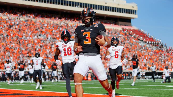 Oklahoma State Cowboys QB Spencer Sanders scores a TD on a 14-yard run against the Texas Tech Red Raiders at Boone Pickens Stadium in Stillwater, Oklahoma.