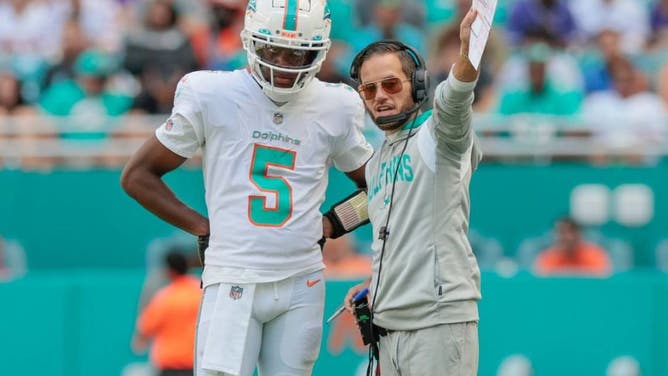 Miami Dolphins QB Teddy Bridgewater and coach Mike McDaniel discuss strategy during game against Minnesota Vikings at Hard Rock Stadium in Miami.