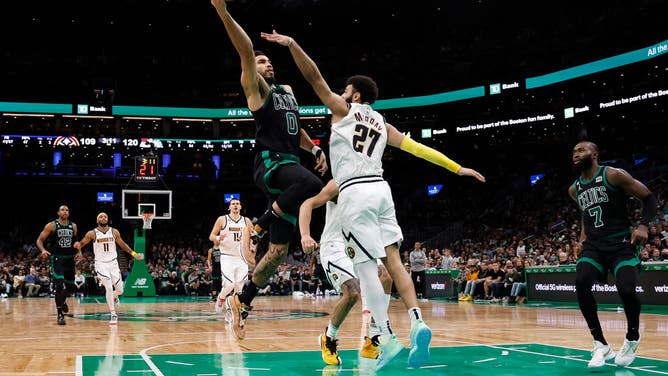 Celtics wing Jayson Tatum goes to the hoop on Denver Nuggets PG Jamal Murray at TD Garden in Boston, Massachusetts.
