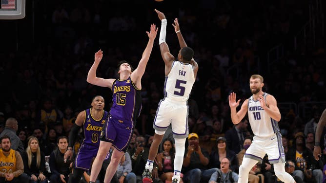 Sacramento Kings PG De'Aaron Fox scores a 3-point basket late in the game against Los Angeles Lakers SG Austin Reaves at Crypto.com Arena in Los Angeles.