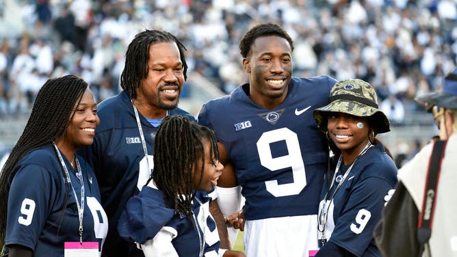 Penn State cornerback Joey Porter, Jr. poses with his dad, former Pittsburgh Steelers linebacker Joey Porter, Sr., and his family during the senior day ceremonies at Beaver Stadium.