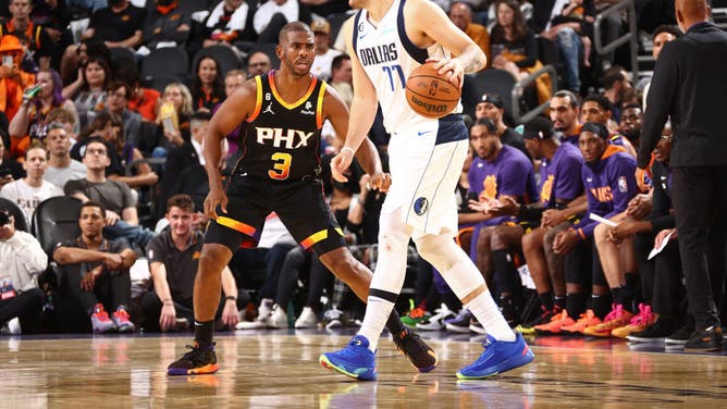 Phoenix Suns PG Chris Paul defends Dallas Mavericks PG Luka Doncic at Footprint Center in Phoenix.