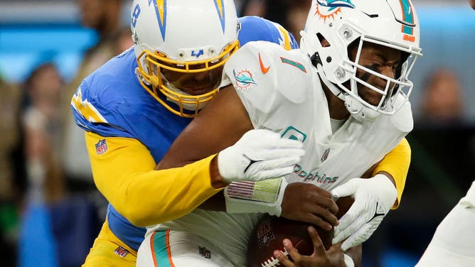 Dolphins QB Tua Tagovailoa tackled by Chargers defender on Sunday Night Football.