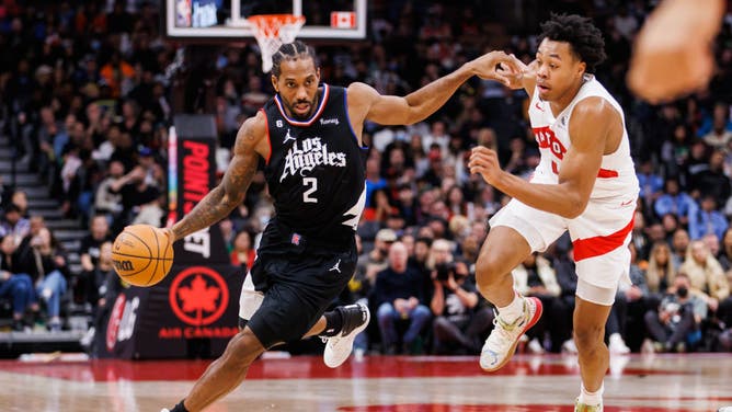 Los Angeles Clippers All-Star Kawhi Leonard dribbles around Raptors wing Scottie Barnes at Scotiabank Arena in Toronto, Canada.