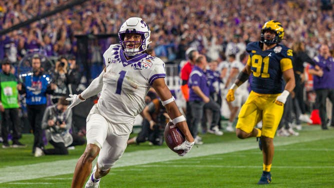 TCU Horned Frogs WR Quentin Johnston runs the ball into the end zone for a TD during the Fiesta Bowl against the Michigan Wolverines at State Farm Stadium in Glendale, Arizona.