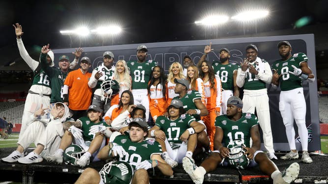 Hooters Girls celebrate with the Ohio Bobcats after defeating Wyoming in the 2022 Barstool Sports Arizona Bowl at Arizona Stadium in Tucson.