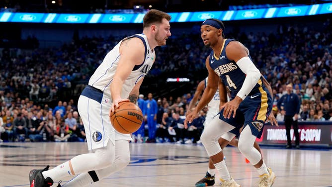 Mavericks wing Luka Doncic controls the ball against Pelicans PG Devonte' Graham at American Airlines Center in Dallas.