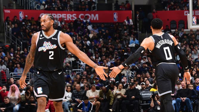 Kawhi Leonard and Russell Westbrook high-five during the game vs. the Kings at Crypto.Com Arena in Los Angeles.