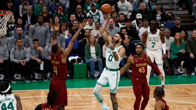 Celtics All-Star Jayson Tatum shoots a floater over Cavaliers big Evan Mobley at TD Garden in Boston.
