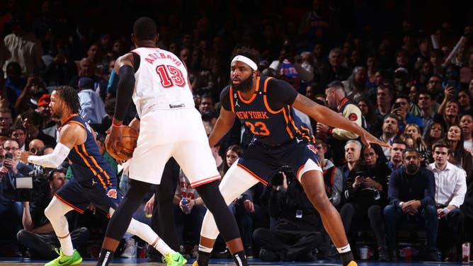 Knicks C Mitchell Robinson defends Heat C Bam Adebayo at Madison Square Garden.