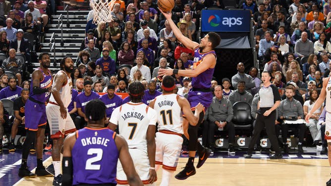 Devin Booker gets a layup against the Nuggets at Footprint Center in Phoenix, Arizona.