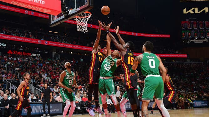 Hawks SF De'Andre Hunter and big Clint Capela fight for a rebound vs. Celtics big Al Horford in Game 3 of the 2023 NBA Playoffs at State Farm Arena.