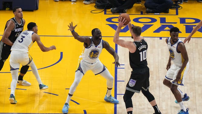 Warriors big Draymond Green defends Kings C Domantas Sabonis in Game 4 of the Western Conference First Round Playoffs at Chase Center.