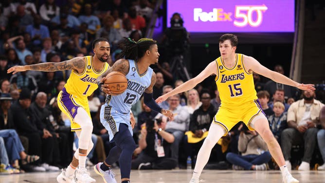 Lakers guards Austin Reaves and D'Angelo Russell defend Morant in Game 5 at FedExForum.