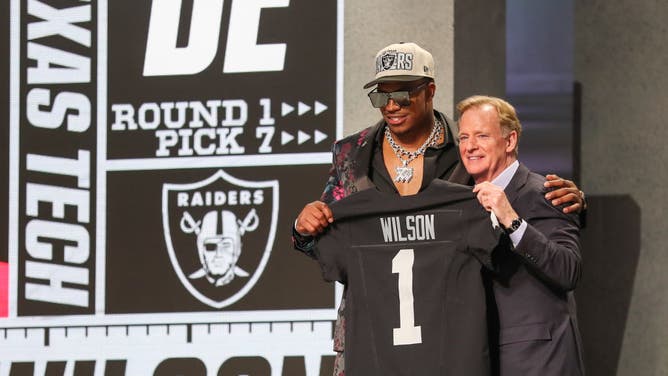 Former Texas Tech DE Tyree Wilson holds a jersey with NFL commissioner Roger Goodell after being drafted in the 1st round of the NFL Draft at Union Station.