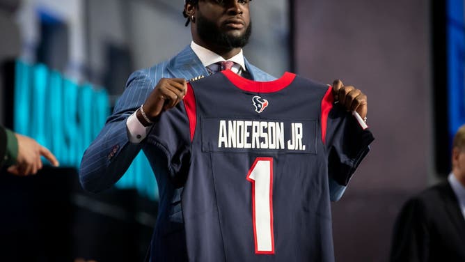 Will Anderson Jr. dons a jersey after being selected to the Houston Texans during the 2023 NFL Draft.