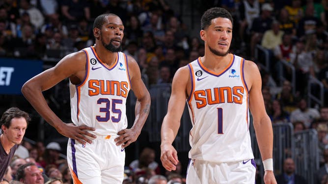 Suns' Devin Booker and Kevin Durant look on during Game 2 of the 2023 NBA Playoffs vs. the Nuggets at the Ball Arena in Denver, Colorado.