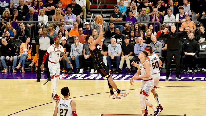 Suns' Devin Booker shoots a fadeaway during Game 3 of the 2023 NBA Playoffs Western Conference Semifinals.