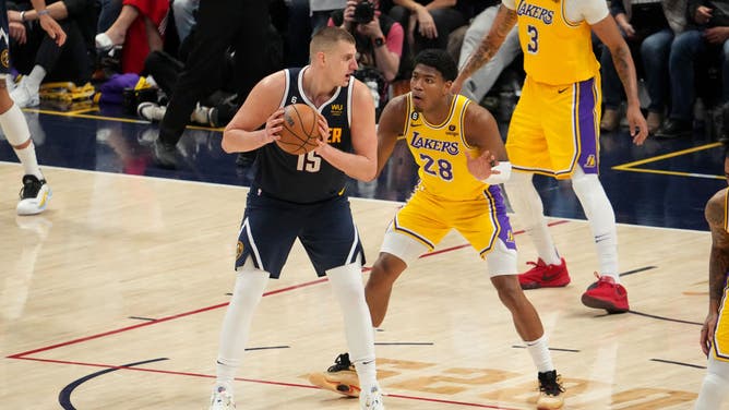 Nuggets C Nikola Jokic handles the ball in the high post with Lakers F Rui Hachimura on defense during Game 2 of the 2023 WCF at the Ball Arena in Denver.