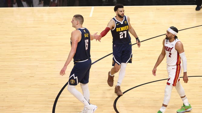 Denver Nuggets C Nikola Jokic and PG Jamal Murray high-five vs. the Heat during Game 4 of the 2023 NBA Finals at Kaseya Center in Miami.