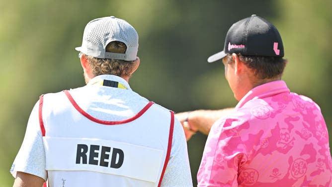Patrick Reed and his caddie talk together during the 123rd U.S. Open Championship at The Los Angeles Country Club.