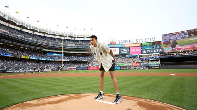 NBA draft Prospect, Victor Wembanyama throws the first pitch before the game between the Seattle Mariners and the New York Yankees at Yankee Stadium.