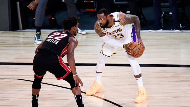 Los Angeles Lakers' LeBron James sizes up Miami Heat SF Jimmy Butler during Game 6 of the 2020 NBA Finals at AdventHealth Arena at the ESPN Wide World Of Sports Complex in Lake Buena Vista, Florida.