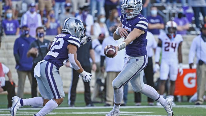 Kansas State Wildcats QB Will Howard hands the ball off to RB Deuce Vaughn against the Oklahoma State Cowboys at Bill Snyder Family Football Stadium in Manhattan, Kansas.