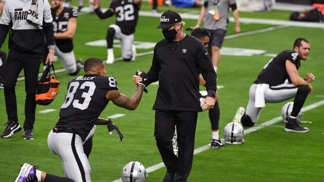 Head coach Jon Gruden of the Las Vegas Raiders greets tight end Darren Waller as he stretches during warmups. Did Gruden prevent Tom Brady from becoming a Raider?