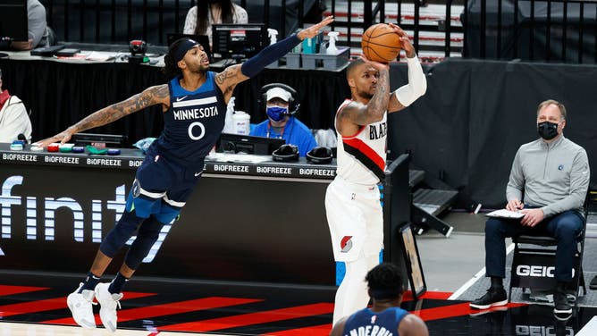 Minnesota Timberwolves PG D'Angelo Russell is caught out of position against Portland Trail Blazers PG Damian Lillard at Moda Center in Portland, Oregon.