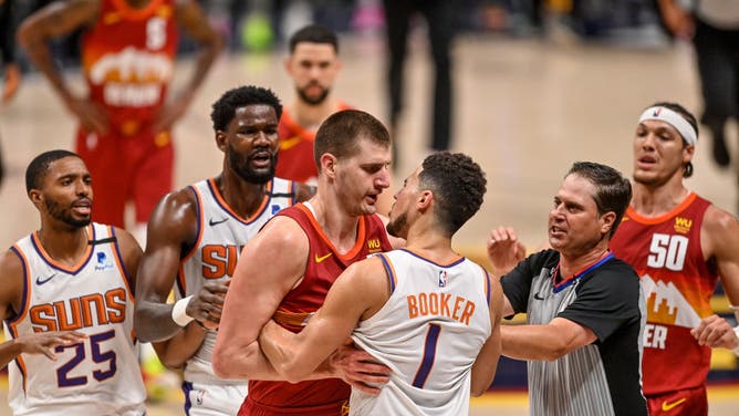 Denver Nuggets C Nikola Jokic and Phoenix Suns SG Devin Booker exchange words during Game 4 of the Western Conference 2nd-round playoff series at Ball Arena in Denver, Colorado.