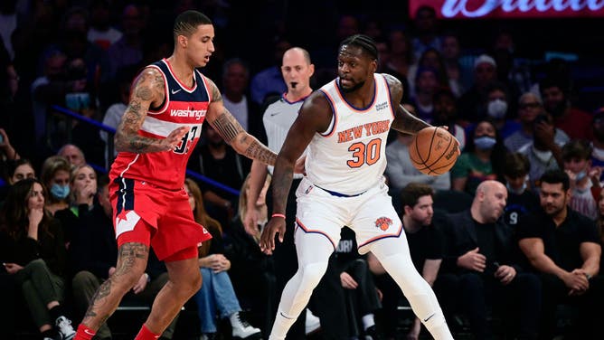 New York Knicks PF Julius Randle posts up Washington Wizards wing Kyle Kuzma at Madison Square Garden.