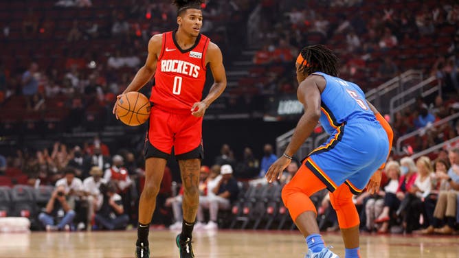 Houston Rockets combo guard Jalen Green handles the ball while defended by Oklahoma City Thunder wing Luguentz Dort at Toyota Center in Houston.