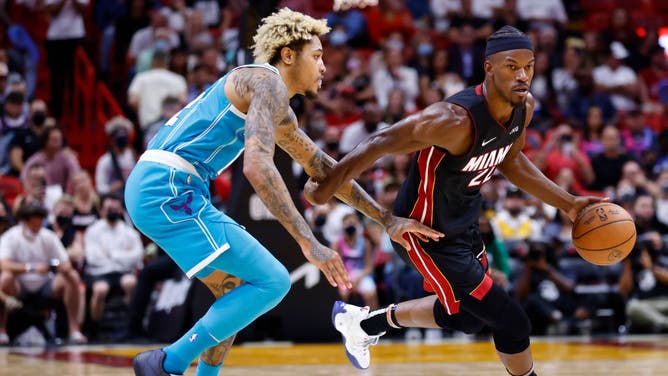 Miami Heat wing Jimmy Butler drives to the basket against Charlotte Hornets wing Kelly Oubre at FTX Arena in Miami.