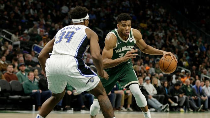 Giannis Antetokounmpo dribbles past Magic big Wendell Carter Jr. at Fiserv Forum in Milwaukee, Wisconsin.