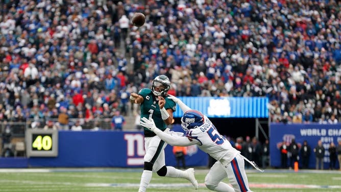 Philadelphia Eagles QB Jalen Hurts in action against New York Giants edge rusher Azeez Ojulari at MetLife Stadium in East Rutherford, New Jersey.