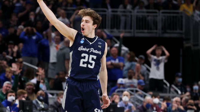 Saint Peter's Peacocks' Doug Edert celebrates after making a 3-pointer basket against the Kentucky Wildcats during the 1st round game of the 2022 NCAA Men's Basketball Tournament at Gainbridge Fieldhouse in Indianapolis.