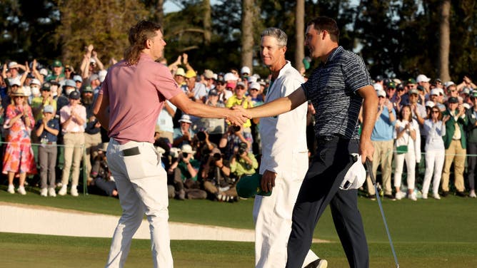 Cameron Smith and Scottie Scheffler shake hands on the 18th green after Scheffler won the 2022 Masters at Augusta National Golf Club.