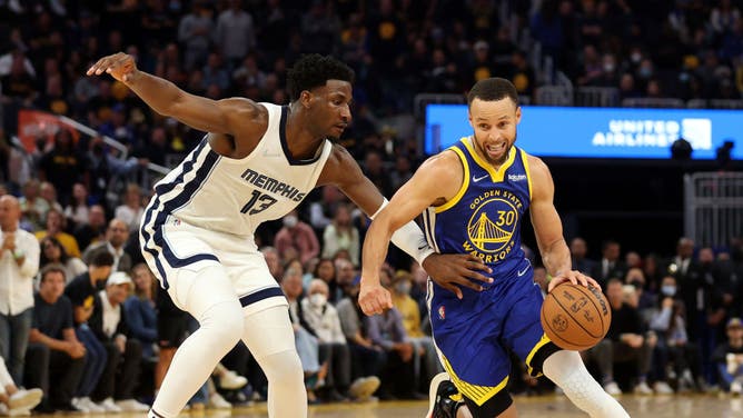 Warriors' Stephen Curry drives against Grizzlies big Jaren Jackson Jr. in Game 6 of the 2022 NBA Playoffs Western Conference Semifinals at Chase Center in San Francisco.