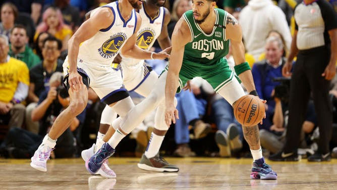 Boston Celtics wing Jayson Tatum backs down Golden State Warriors' Stephen Curry in Game 1 of the 2022 NBA Finals at Chase Center in San Francisco.