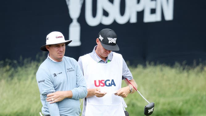 Joel Dahmen stands with his caddie Geno Bonnalie during round one of the 122nd US Open Championship.