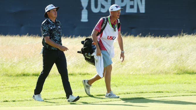 Joel Dahmen walks on the 14th hole with caddie Geno Bonnalie during the second round of the 122nd US Open Championship.