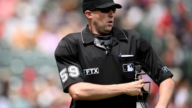 Umpire Nic Lentz walks across the field during a game.