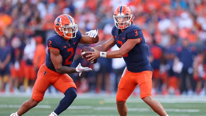 Former Illinois QB Tommy DeVito hands the ball off to former RB Chase Brown vs. the Wyoming Cowboys at Memorial in Champaign.