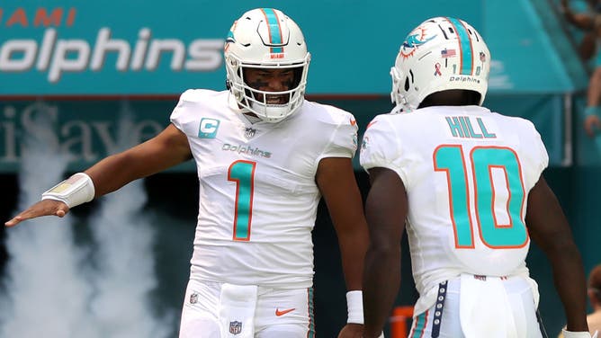 Tua Tagovailoa and Tyreek Hill of the Miami Dolphins are introduced prior to a game.