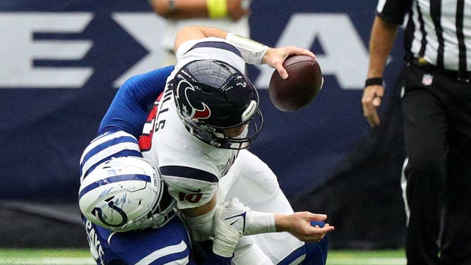 Houston Texans quarterback Davis Mills is sacked by Indianapolis Colts defensive end Kwity Paye.