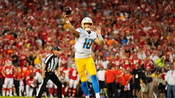 Los Angeles Chargers QB Justin Herbert elevates for the throw against the Kansas City Chiefs at GEHA Field at Arrowhead Stadium in Kansas City, Missouri.