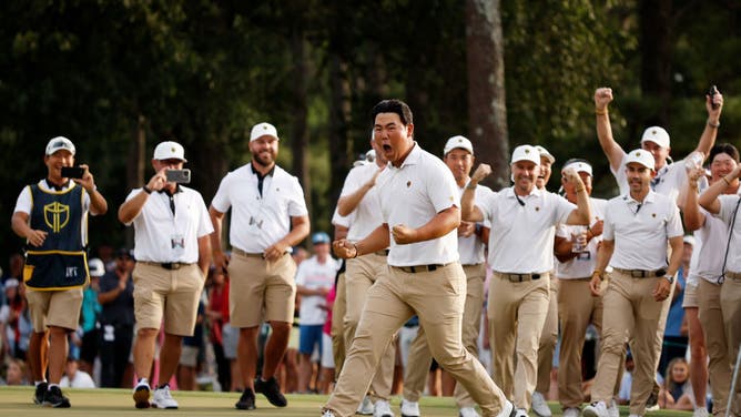 Tom Kim celebrates his hole-winning putt with teammate Si Woo Kim vs. Patrick Cantlay and Xander Schauffele at the 2022 Presidents Cup at Quail Hollow in Charlotte, North Carolina.
