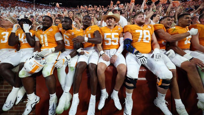 The Tennessee Volunteers team celebrates in the stands with the fans after a win against the Florida Gators at Neyland Stadium in Knoxville, Tennessee.